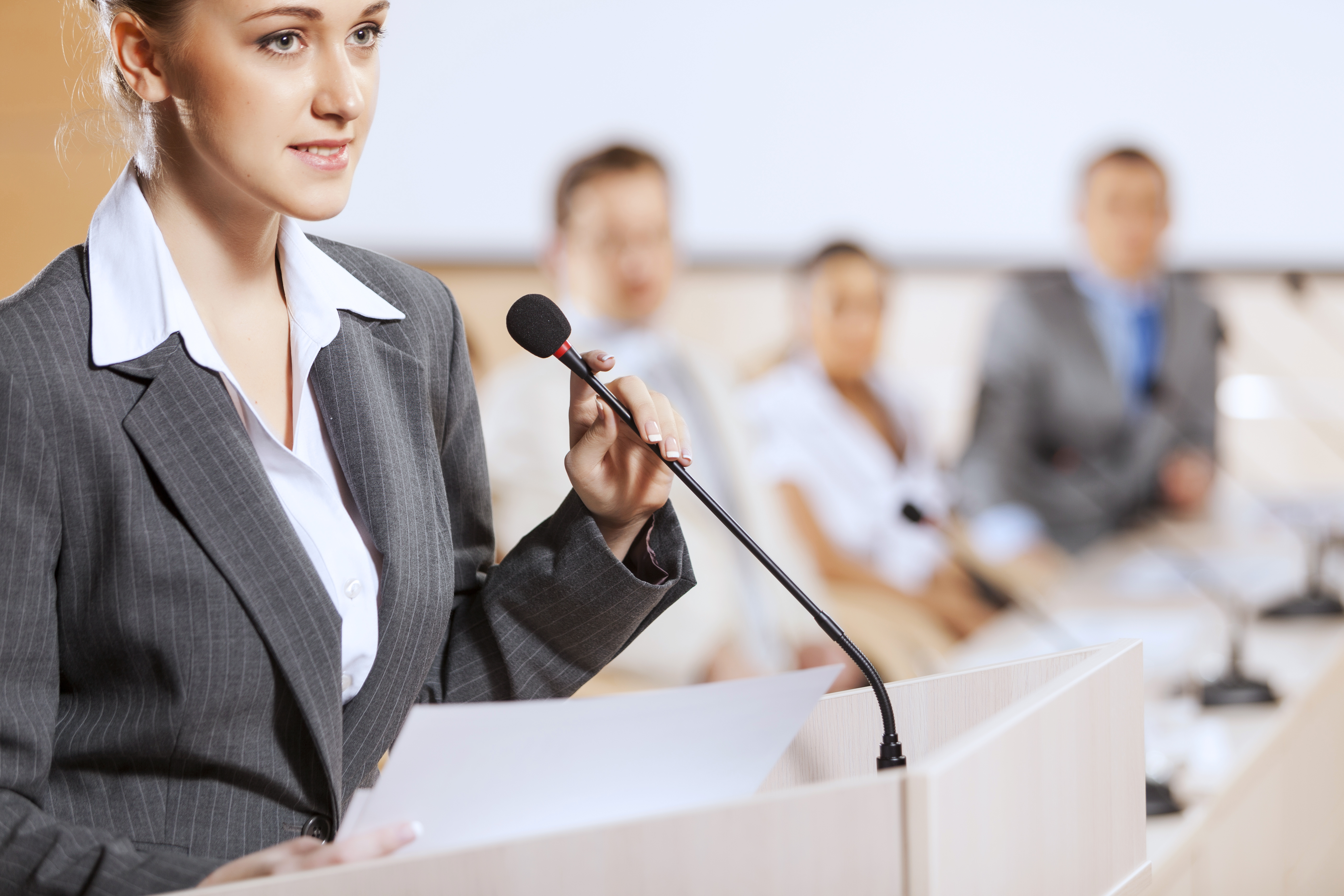 A person talking at a talking desk